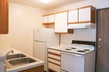 Fargo apartment for rent - a kitchen with white appliances and a sink and a refrigerator