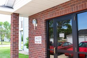 Fargo apartment for rent - the front door of a brick building with a sign that reads 1423 on it
