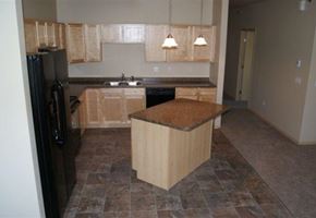 West Fargo apartment for rent - an empty kitchen with a counter top and a refrigerator