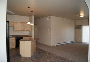 West Fargo apartment for rent - an empty living room with an empty kitchen with an island