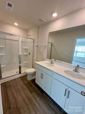 Charlotte house for rent - A bathroom with a toilet, sink, and shower.