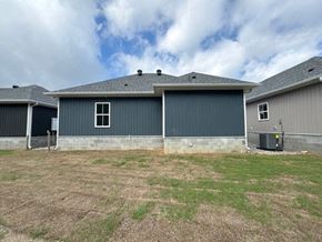 Little Rock house for rent - A large grey building with a grey roof and a grey garage door.