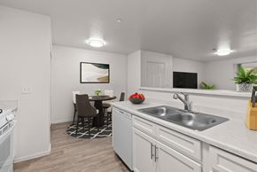 Reno apartment for rent - A kitchen with a dining table and chairs.