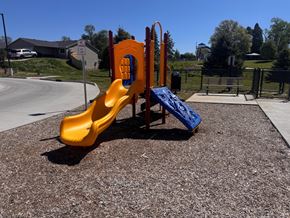 Grinnell apartment for rent - A playground with a yellow slide and a blue slide.