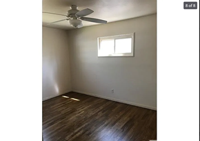 St. Louis house for rent - A room with a ceiling fan and a window.