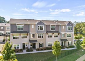 Greenville house for rent - A row of townhouses with a black fence in front.