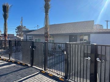 Las Vegas apartment for rent - A black metal fence with a gate is in front of a house.