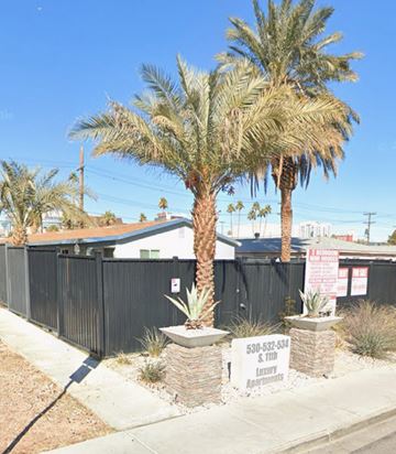 Las Vegas apartment for rent - A palm tree stands in front of a sign for a funeral home.