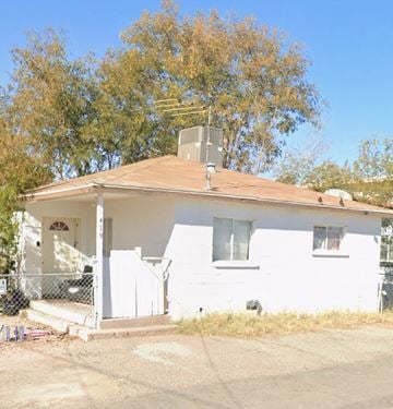Las Vegas apartment for rent - A white house with a brown roof and a fence in front.