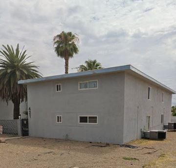 Las Vegas apartment for rent - A house with a grey exterior and a palm tree in front.