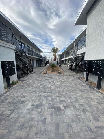 Las Vegas apartment for rent - A long, narrow walkway with black railings on both sides.