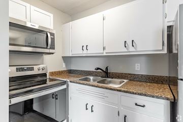 Murfreesboro apartment for rent - A kitchen with white cabinets and a granite countertop.