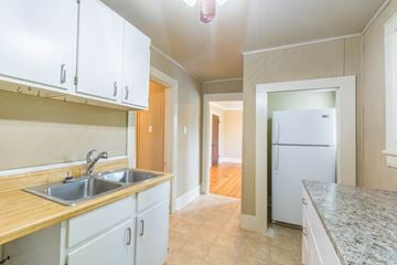 Little Rock apartment for rent - A kitchen with white cabinets and a granite countertop.