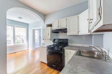 Little Rock apartment for rent - A kitchen with a stove top oven and a sink.