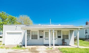Peoria Heights house for rent - A small house with a porch and a garage.