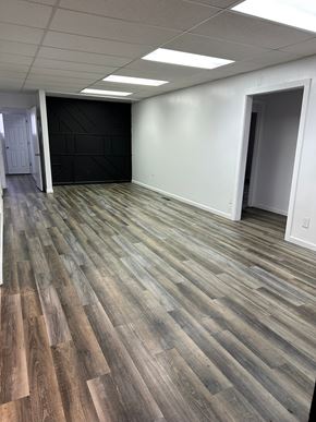 Grandview house for rent - A room with a wooden floor and white walls.