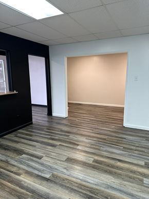 Grandview house for rent - A room with a wooden floor and white walls.