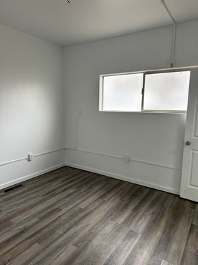 Grandview house for rent - A room with a window and wooden flooring.