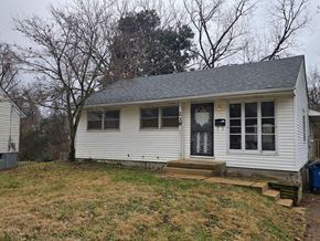 Saint Louis house for rent - A small white house with a grey roof and a black door.
