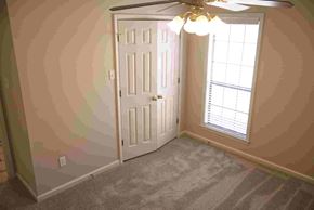 Conway apartment for rent - A room with a white door and a ceiling fan with lights.