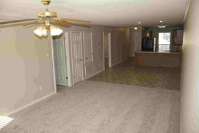 Conway apartment for rent - A room with a ceiling fan and a door leading to another room.