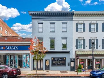 Frederick apartment for rent - A street view with a building that has a sign that says "STAGES" on it.