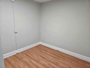 Frederick apartment for rent - A room with a wooden floor and a white wall.