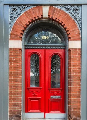 Frederick apartment for rent - A red door with a glass window and a sign that says "No Trespassing".