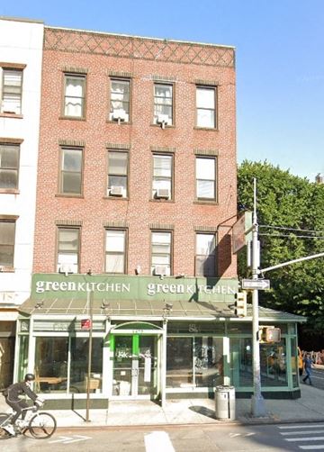 New York apartment for rent - A red brick building with a green awning that says Green Kitchen.