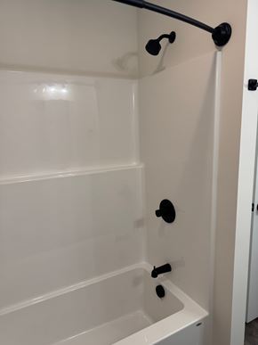 Mccomb apartment for rent - A white bathroom with a shower and a door.