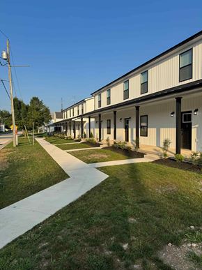 Mccomb apartment for rent - A long building with a walkway in front.