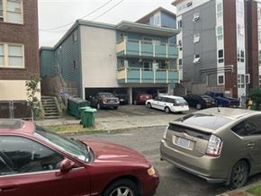 Seattle apartment for rent - A red car is parked in a parking lot.
