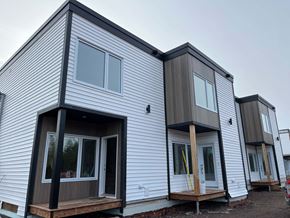 Guysborough apartment for rent - A row of houses with white siding and dark trim.