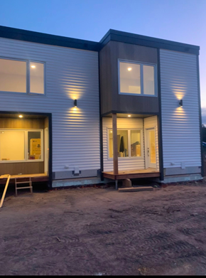 Guysborough apartment for rent - A modern house with a grey exterior and a white door is shown.