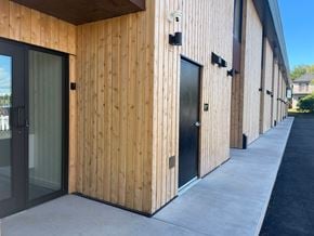 Lunenburg apartment for rent - A building with wooden walls and black doors.