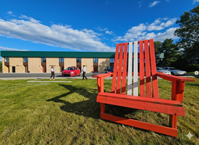 Lunenburg apartment for rent - A red and white striped bench sits in the foreground of a grassy area.