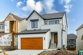 Airdrie house for rent - A house under construction with a brown garage door.