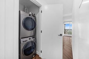 Calgary apartment for rent - A washer and dryer are stacked in a small space.