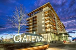 Calgary apartment for rent - A modern building with the name "Gateway" on a sign in front of it.