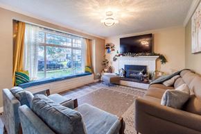 Victoria apartment for rent - A living room with a fireplace and a flat screen TV.
