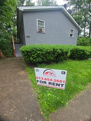 Norwood apartment for rent - A blue house with a sign in front that says "For Rent".