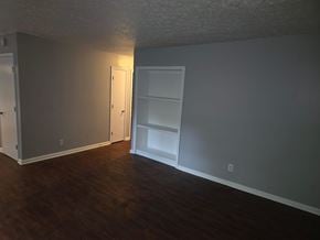 Norwood apartment for rent - A room with a white door and a white shelf unit.