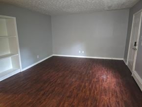 Norwood apartment for rent - A room with wooden flooring and white walls.