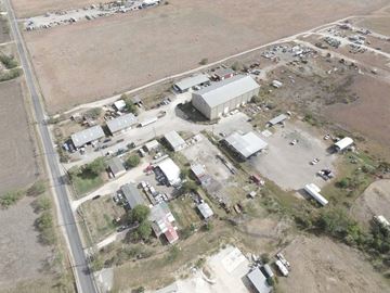 Converse apartment for rent - An aerial view of a large building surrounded by smaller structures and vehicles.