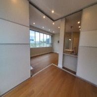 Toronto apartment for rent - A room with a wooden floor and white walls.
