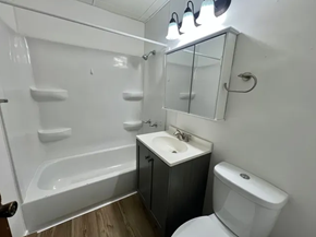 Fargo apartment for rent - A white sink is on a black cabinet in a bathroom.