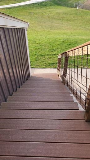 Ligonier house for rent - A set of stairs with a metal railing leading to a grassy area.