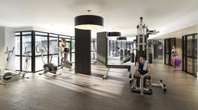 Toronto apartment for rent - A gym with a man working out on a rowing machine.