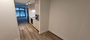Hamilton apartment for rent - A kitchen area with a counter and a fridge.