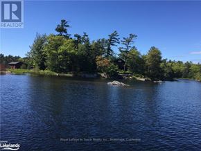 The Archipelago (Archipelago South) house for rent - A serene landscape with a dock and a boat on a lake surrounded by trees.